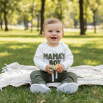 Children's outfit with white shirt and green pants on a light background