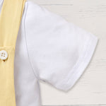 Baby boy wearing a stylish summer gentleman romper set with suspenders