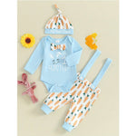 Baby Easter outfit with blue onesie, carrot-patterned pants, and matching hat on a beige background.