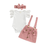 Baby outfit set with white onesie, pink skirt, and headband on a white background