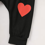 Black Pants with a red heart on a white background