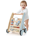 Child playing with a wooden toy walker on a white background