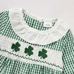 Green and white checkered dress with shamrock designs on a white background