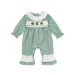 Green checkered baby romper with shamrock design on a white background