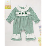 Green checkered baby romper with shamrock design on a white background