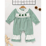 Newborn baby girl wearing a green plaid long sleeve bodysuit