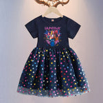 Ninjago-themed children's dress with colorful heart pattern on a hanger against a neutral background