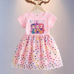Pink dress with cartoon characters and colorful heart pattern on a hanger against a light gray background