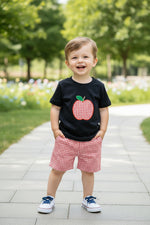 Toddler boy wearing a stylish summer T-shirt and red gingham shorts outfit