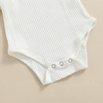 White ribbed baby bodysuit on a beige background