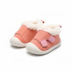 Pair of soft pink fleece-lined baby booties with adjustable straps.